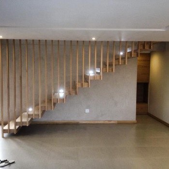 Floating Oak staircase with Panga Panga inlays and vertical Oak fins